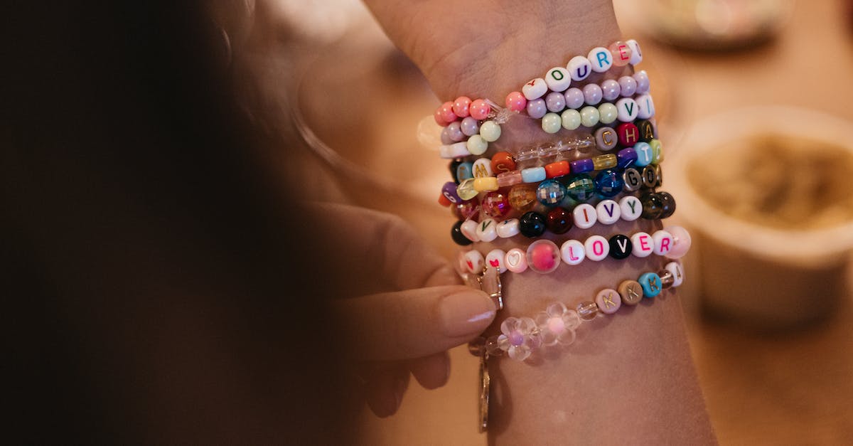 A woman is holding a bracelet with a bunch of beads