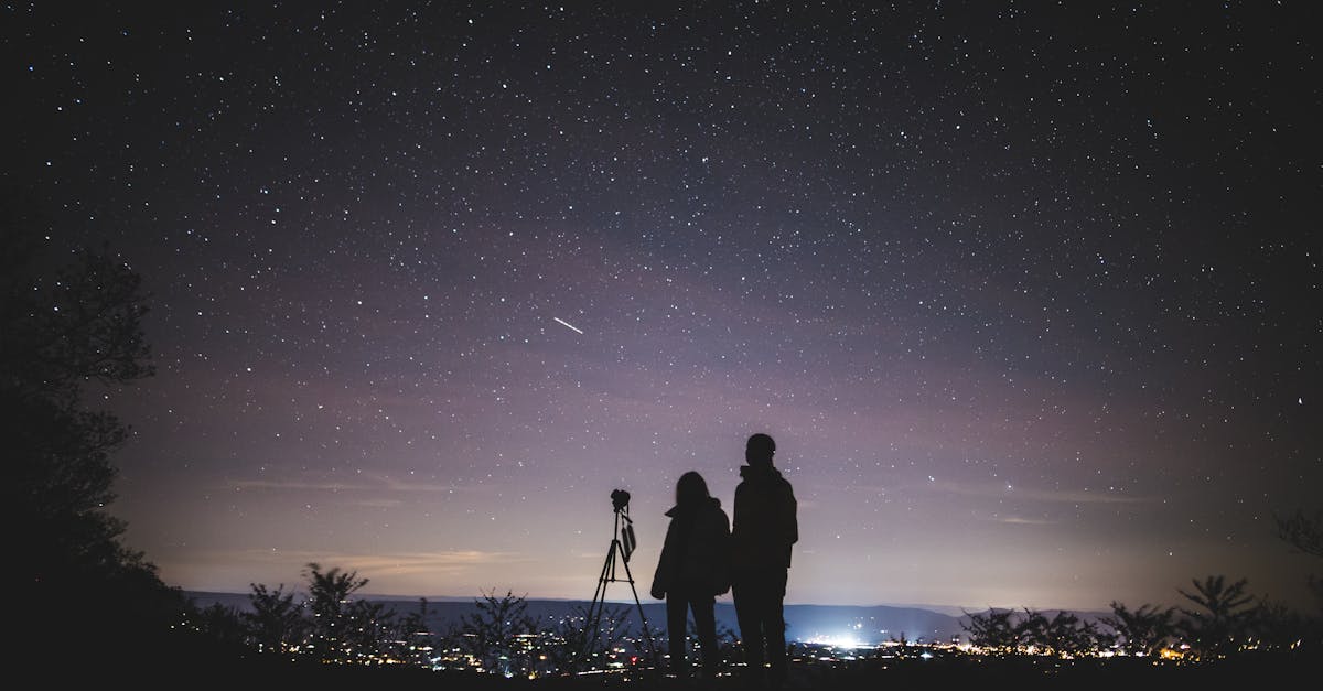 Silhouette of Two Persons Stargazing 