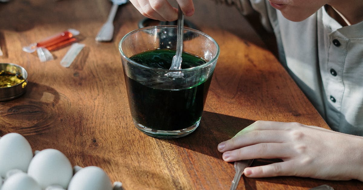 Boy Mixing Color in Glass Cup