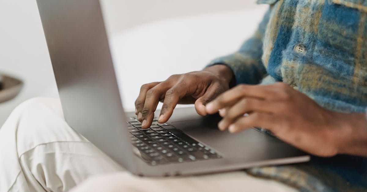 African American man in casual clothes using laptop