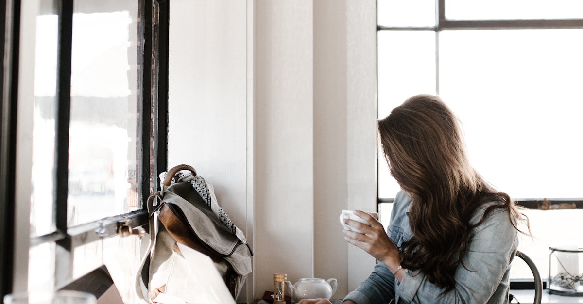 Woman in Gray Jacket Sitting Beside Desk