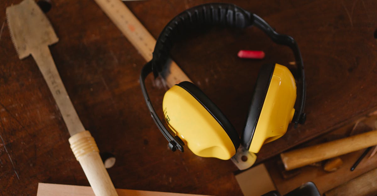 Protective headphones near carpentry tools on workbench