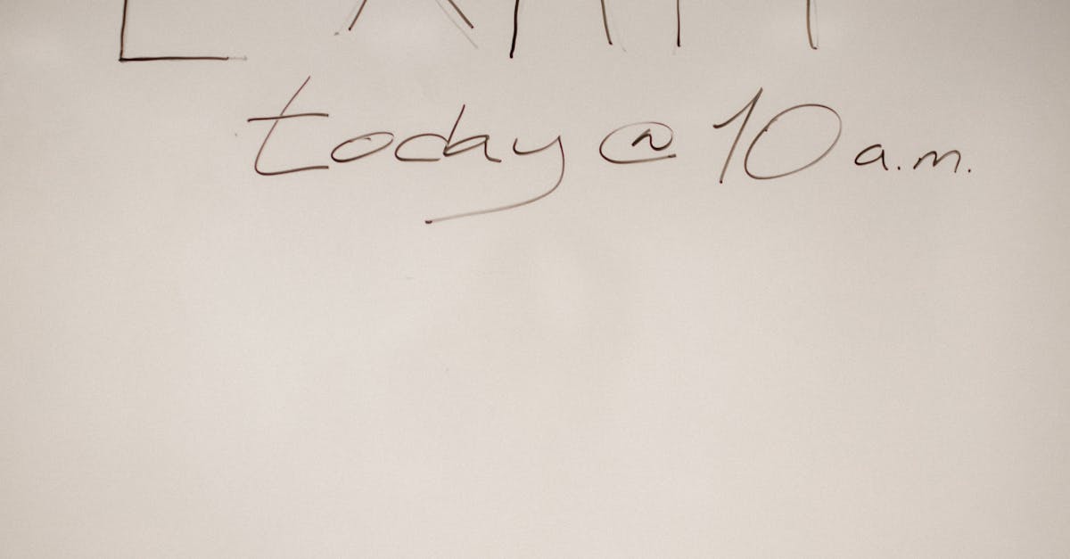 A whiteboard message announcing an exam scheduled for today at 10 a.m. in a classroom setting.