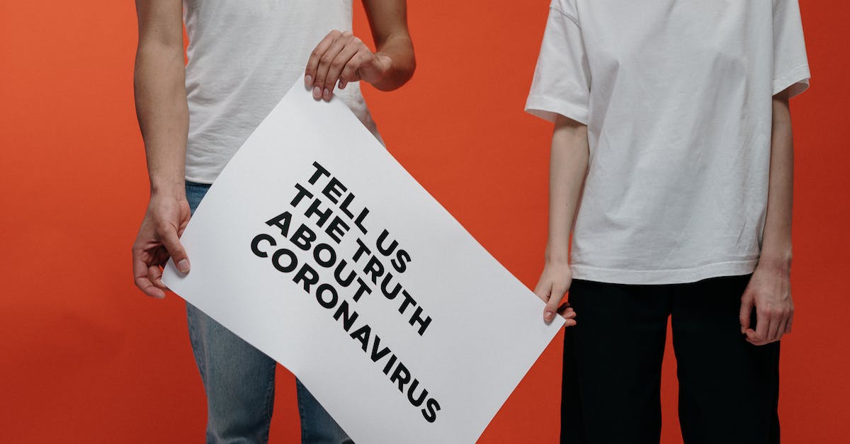 People Holding A Poster Asking About The Truth In Coronavirus
