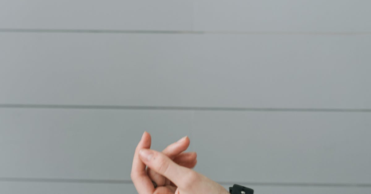 Person in White Long Sleeve Shirt Wearing Smartwatch