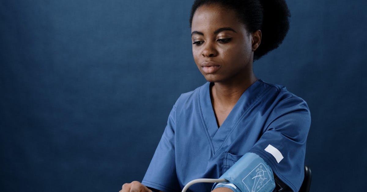 A Healthcare Worker Measuring Her Own Blood Pressure Using a Sphygmomanometer