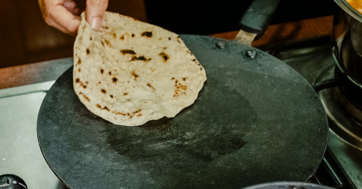 A Person Cooking Chapati on Tava