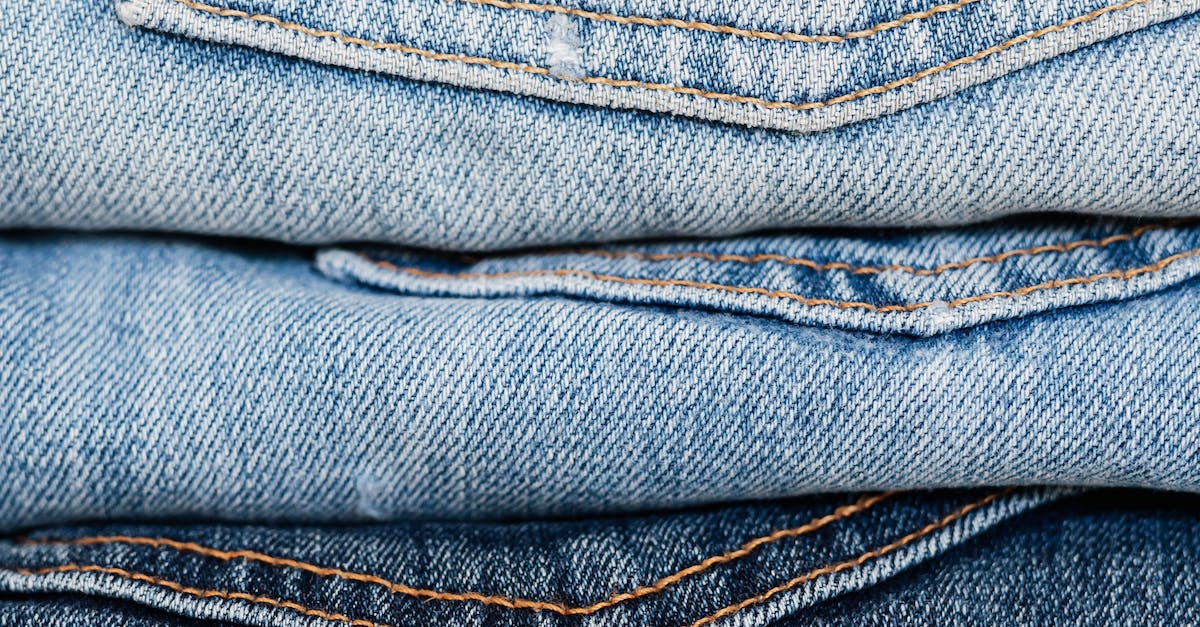 Stack of blue jeans arranged by color