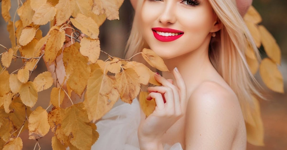 Portrait of Blonde Woman Among Golden Leaves 