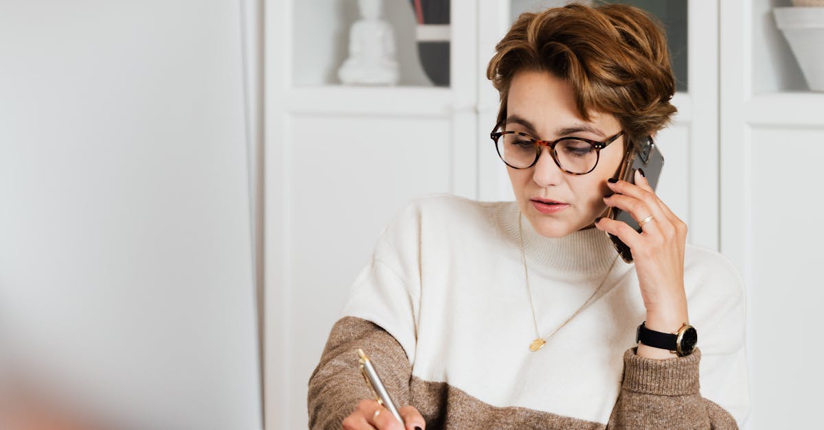 Modern businesswoman in casual outfit talking on mobile in office