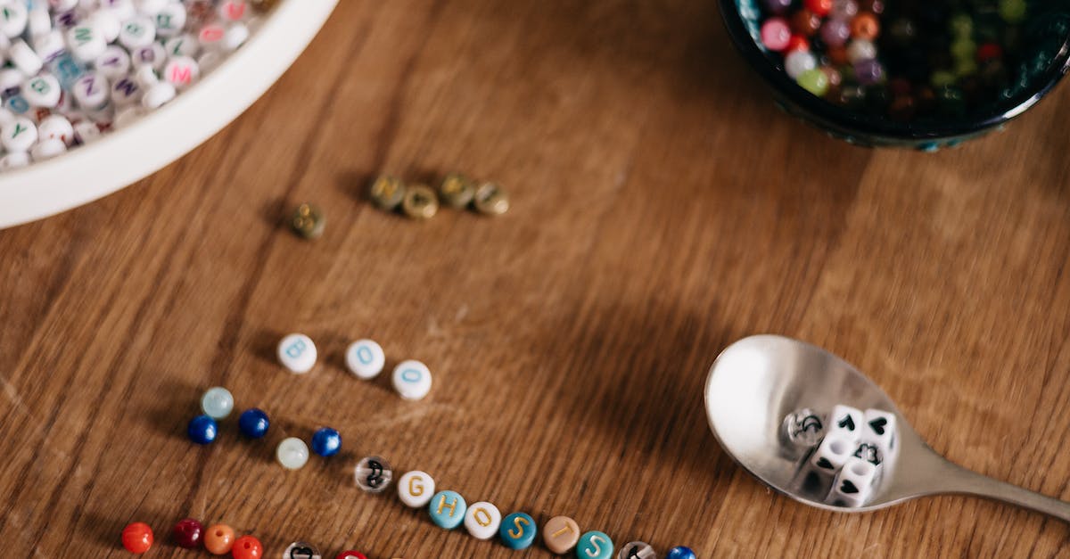 A table with beads, beads and a spoon