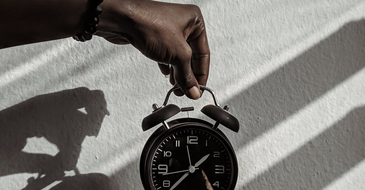 Person Holding a Alarm Clock