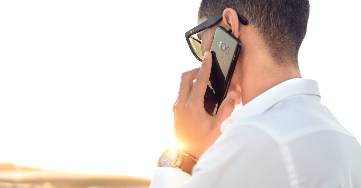 Shallow Focus Photography of a Man in White Collared Dress Shirt Talking to the Phone Using Black Android Smartphone