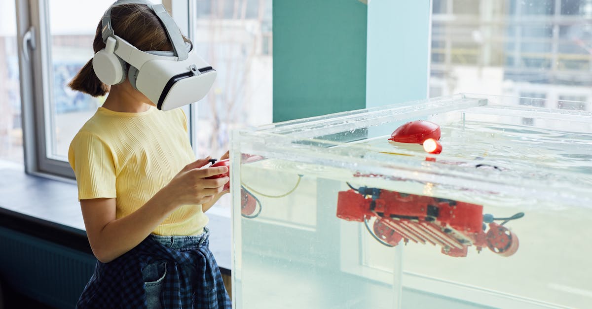 Side view of little girl wearing VR goggles and exploring new robot with controllers in light room
