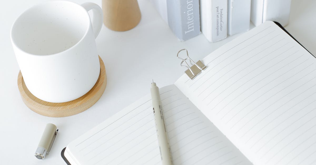 Notebook opened on desk near books