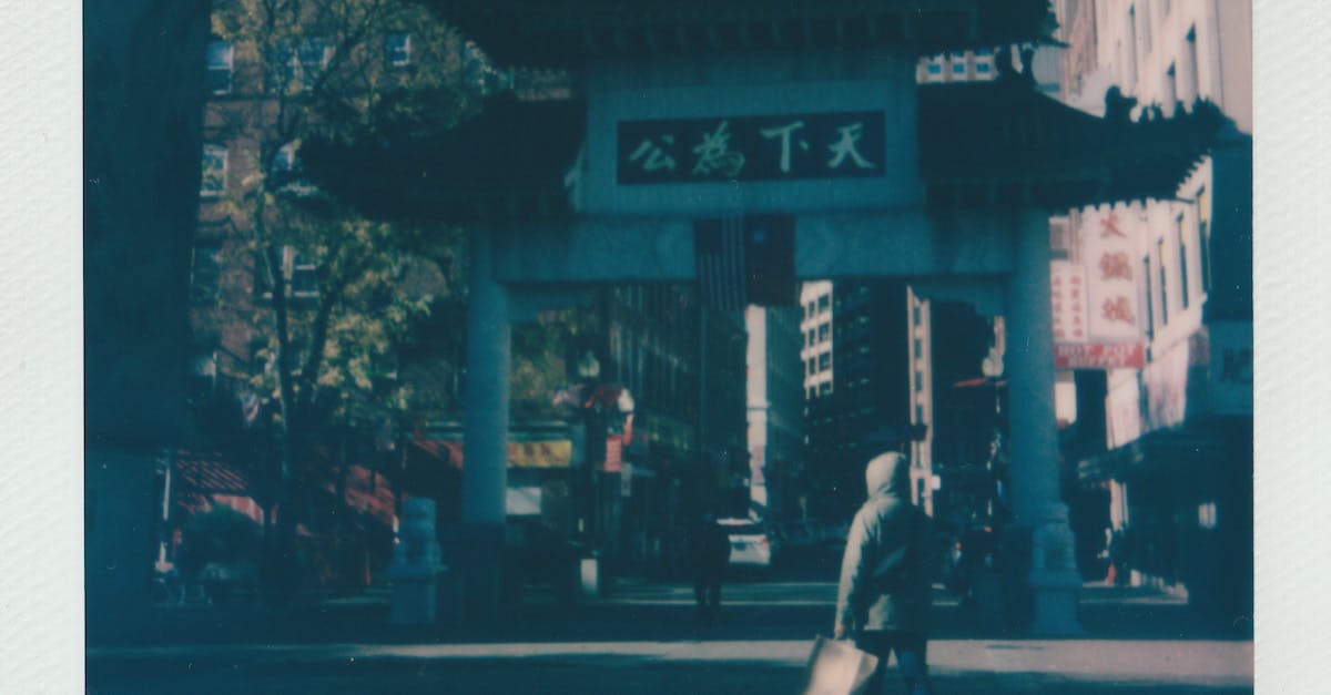 Woman in Black Jacket Walking on Sidewalk